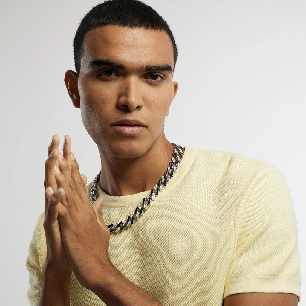 A man wearing a black Cuban link chain