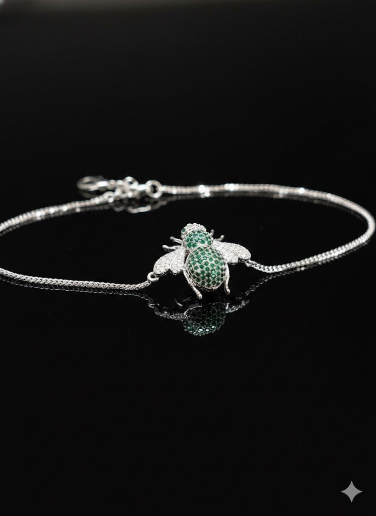 WRAPGAME INDIA silver chain bracelet with a green and white jeweled bee charm. Adjustable chain.