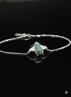 WRAPGAME INDIA silver chain bracelet with a green and white jeweled bee charm. Adjustable chain.