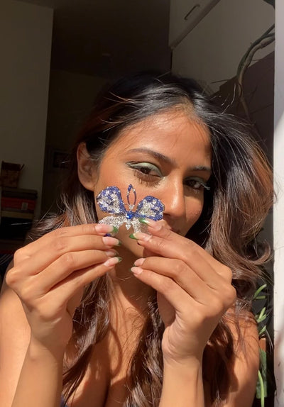 A GIRL HOLDING PAPILLON BROOCH BUTTERFLY BROOCH